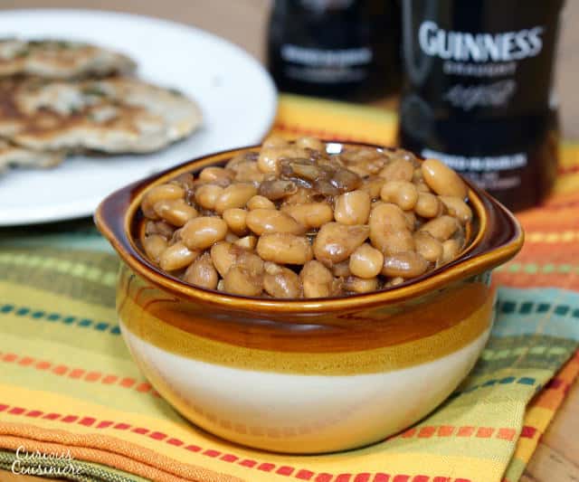 Not your classic sweet and sticky BBQ Baked Beans, these Guinness Baked Beans boast a mild and malty sweetness with a deep and robust flavor. | www.CuriousCuisiniere.com