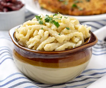 https://www.curiouscuisiniere.com/wp-content/uploads/2015/03/German-Spaetzle-German-Dumplings-or-German-Pasta-7428-450.jpg.webp