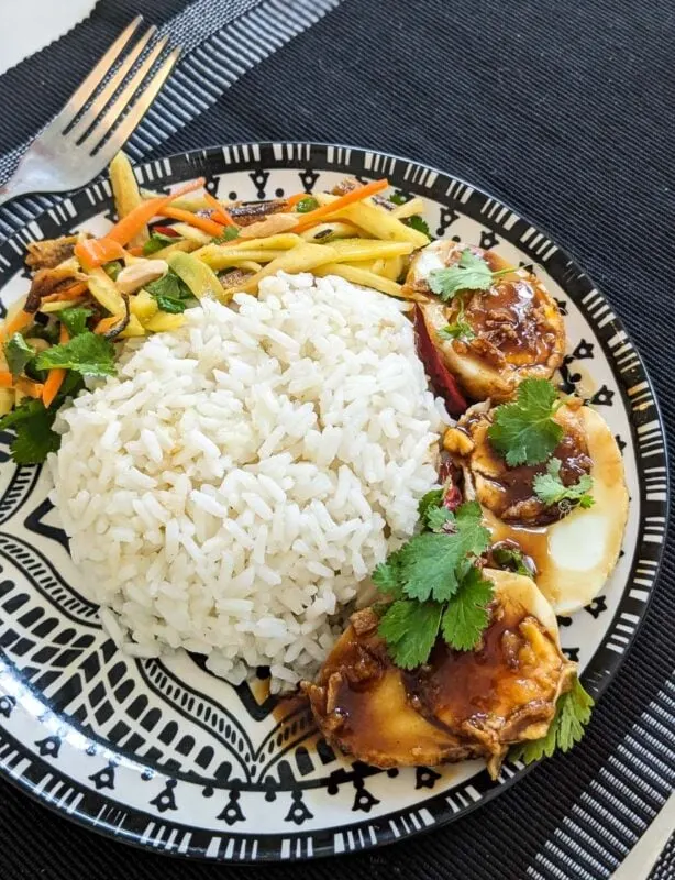 Son-in-law eggs served with rice and Thai mango salad