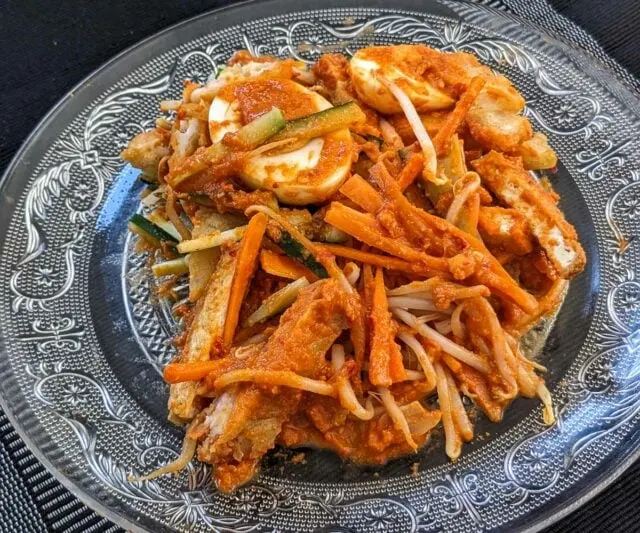 Pasembur (Malaysian Indian Rojak) salad after mixing - warm salad with vegetables, egg, tofu, and a creamy dressing