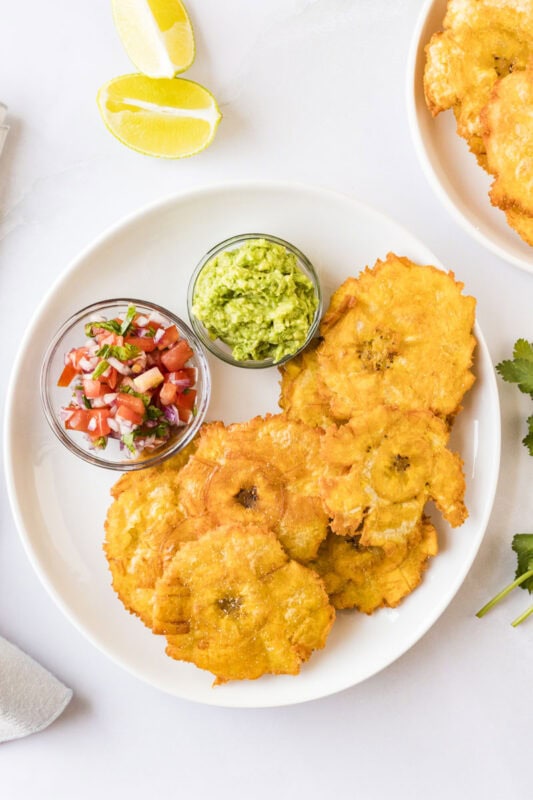 Patacones, tostones, fried plantains, with guacamole and pico de gallo