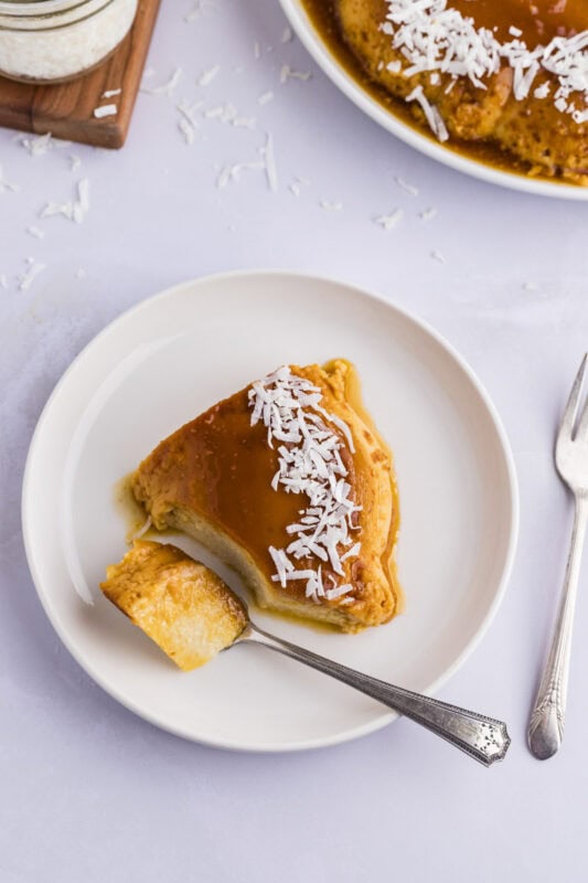 Coconut flan slice - taking a bite of a Caribbean dessert