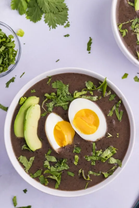 Sopa Negra (Costa Rican Black Bean Soup) - served with egg and avocado