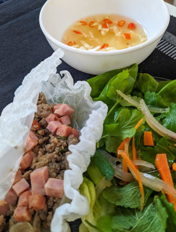 Pak mo krob - Vietnamese crispy rice paper wraps filled with pork and sausage, served with lettuce and a chili garlic dipping sauce